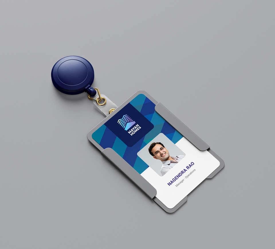 Mayan Homes employee ID badge for Nagendra Rao, Manager - Operations, featuring company logo and retractable badge holder on gray background